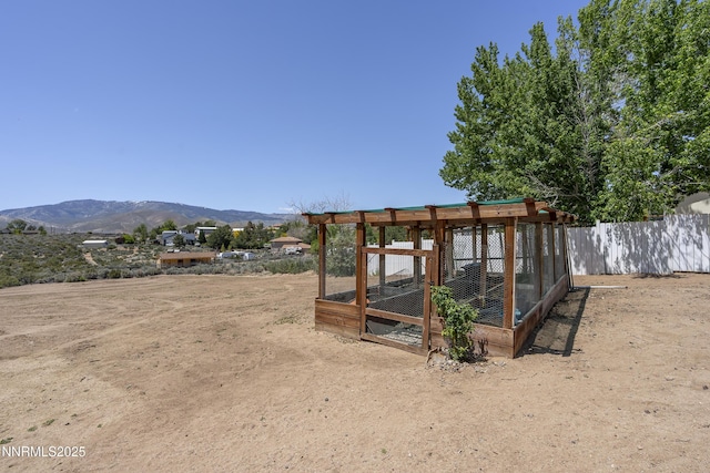 4840 Gentry Ln, Carson City, NV 89701 - view of yard featuring exterior structure, a mountain view, and an outbuilding