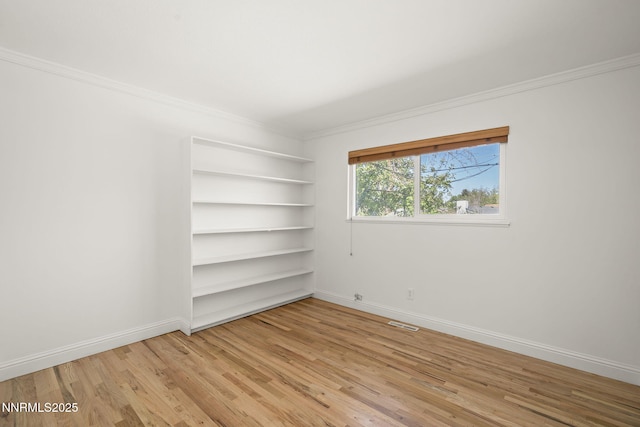 1420 Exeter Way, Reno, NV 89503 - empty room with crown molding, light wood-type flooring, baseboards, and built in shelves