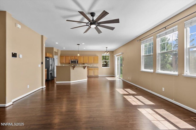 6595 Geranium Way, Sparks, NV 89436 - unfurnished living room with dark wood-style floors, baseboards, and a ceiling fan