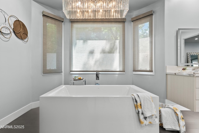 4485 Mountaingate Dr, Reno, NV 89519 - bathroom featuring a chandelier, a soaking tub, vanity, and baseboards