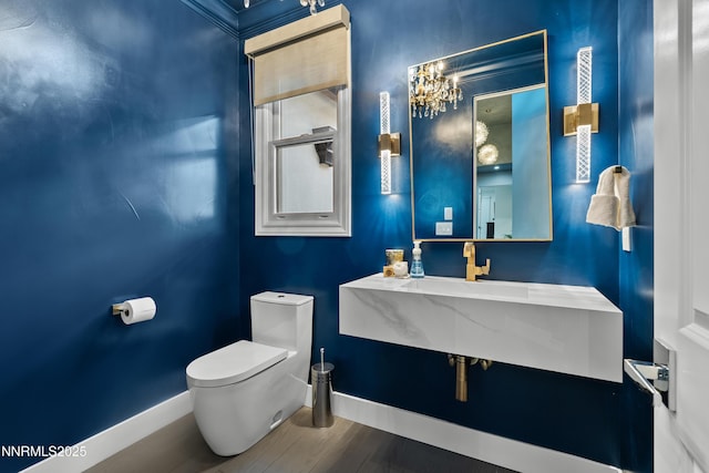4485 Mountaingate Dr, Reno, NV 89519 - half bathroom featuring baseboards, toilet, wood finished floors, a sink, and a chandelier