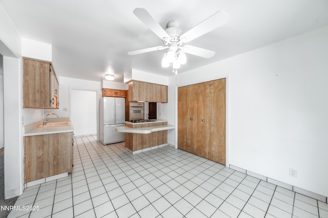 745 Rosewood Dr, Reno, NV 89509 - kitchen with white appliances, light countertops, a sink, a peninsula, and a ceiling fan