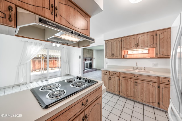 745 Rosewood Dr, Reno, NV 89509 - kitchen with electric cooktop, a sink, under cabinet range hood, light countertops, and white fridge