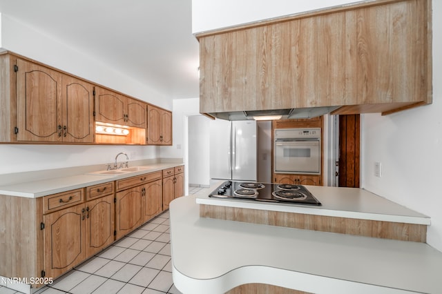 745 Rosewood Dr, Reno, NV 89509 - kitchen with white appliances, a sink, a peninsula, light countertops, and light tile patterned floors