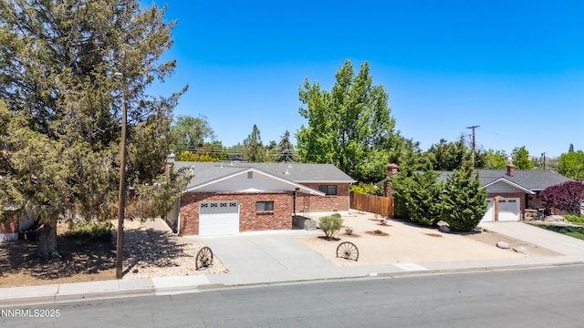 745 Rosewood Dr, Reno, NV 89509 - view of front of property with an attached garage, brick siding, and concrete driveway