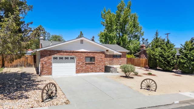 745 Rosewood Dr, Reno, NV 89509 - view of side of property featuring concrete driveway, brick siding, a garage, and a chimney