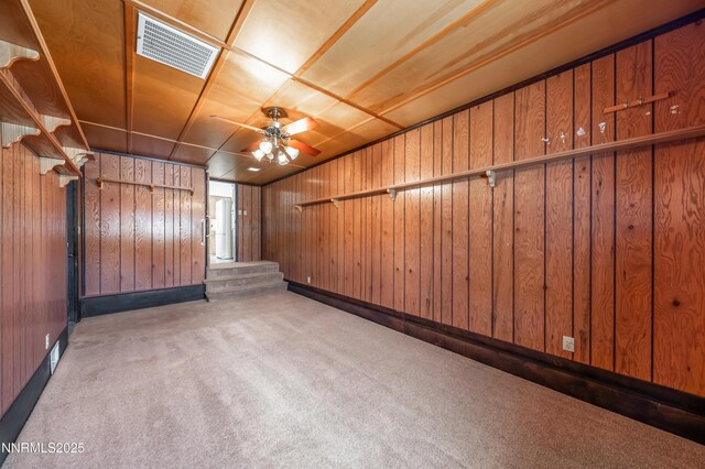 745 Rosewood Dr, Reno, NV 89509 - spare room with carpet, wooden walls, and a ceiling fan