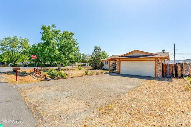 12 S Patterson Pl, Sparks, NV 89436 - view of front of house with asphalt driveway, an attached garage, and stone siding