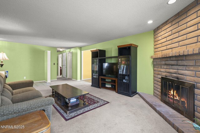 12 S Patterson Pl, Sparks, NV 89436 - living room featuring a textured ceiling, a brick fireplace, recessed lighting, carpet floors, and baseboards