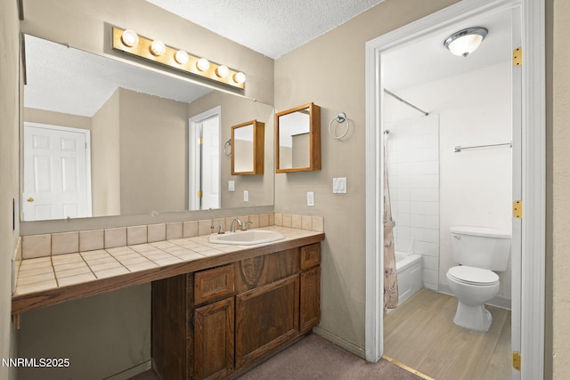 12 S Patterson Pl, Sparks, NV 89436 - bathroom featuring vanity, toilet, shower / tub combination, a textured ceiling, and wood finished floors