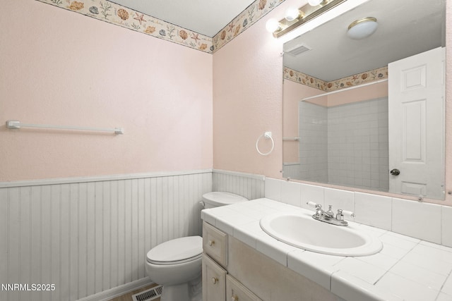 12 S Patterson Pl, Sparks, NV 89436 - bathroom featuring a wainscoted wall, toilet, vanity, and a shower
