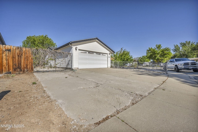 2480 Meadowbrook Ln, Carson City, NV 89701 - garage featuring concrete driveway and a gate