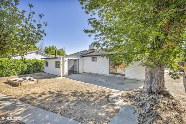 2480 Meadowbrook Ln, Carson City, NV 89701 - rear view of house with a patio and a garden