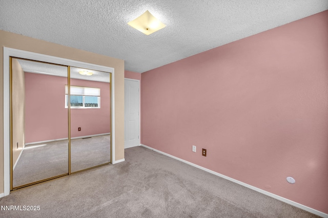 2480 Meadowbrook Ln, Carson City, NV 89701 - unfurnished bedroom with a textured ceiling, a closet, carpet, and baseboards