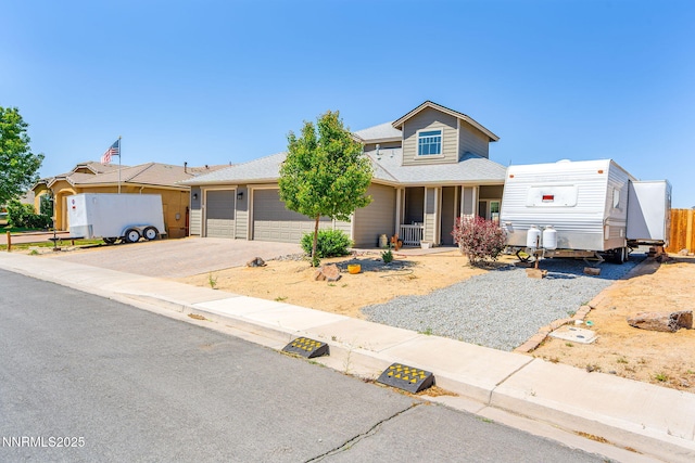 2266 Hayfield Ln, Fernley, NV 89408 - view of front of house with driveway, an attached garage, a porch, and a shingled roof