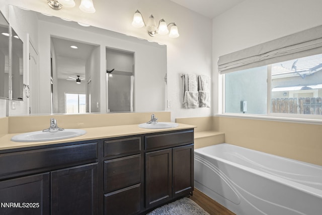 2266 Hayfield Ln, Fernley, NV 89408 - full bathroom featuring double vanity, a bath, a ceiling fan, and wood finished floors