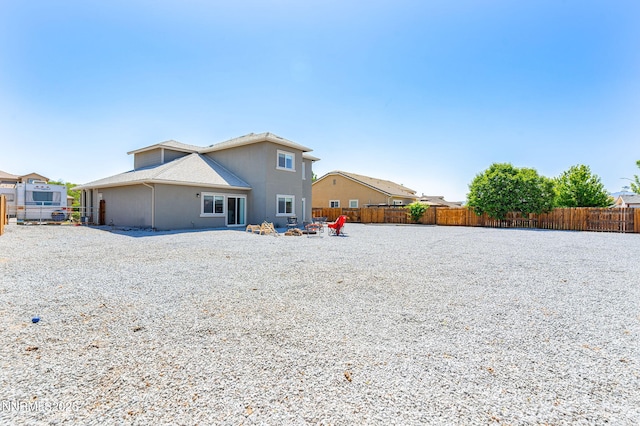 2266 Hayfield Ln, Fernley, NV 89408 - back of house featuring a fenced backyard and a fire pit