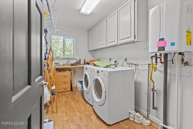 742 Long Valley Rd, Gardnerville, NV 89460 - laundry area featuring water heater, independent washer and dryer, light wood-style flooring, and cabinet space