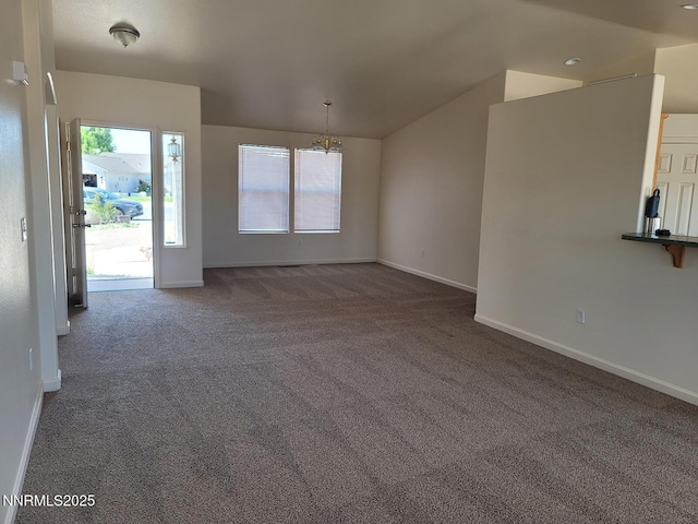 159 Shadow Mountain Dr, Fernley, NV 89408 - unfurnished living room featuring carpet floors, a chandelier, vaulted ceiling, baseboards, and healthy amount of natural light