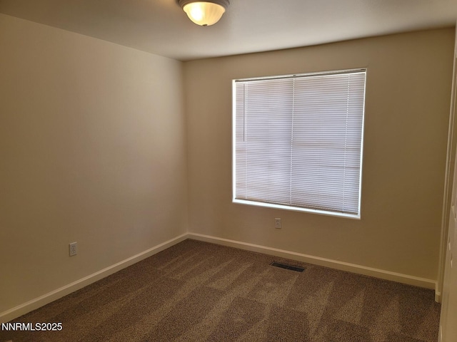 159 Shadow Mountain Dr, Fernley, NV 89408 - spare room with dark carpet and baseboards