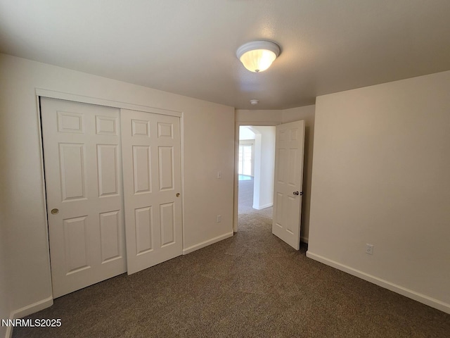 159 Shadow Mountain Dr, Fernley, NV 89408 - unfurnished bedroom with dark carpet, baseboards, and a closet