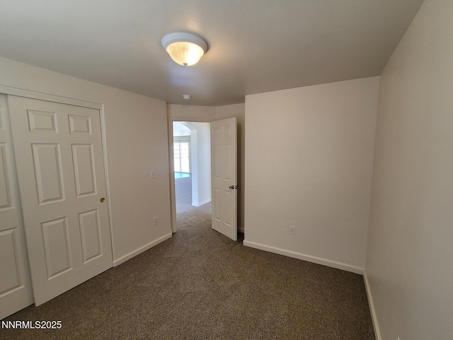 159 Shadow Mountain Dr, Fernley, NV 89408 - unfurnished bedroom featuring dark colored carpet and baseboards