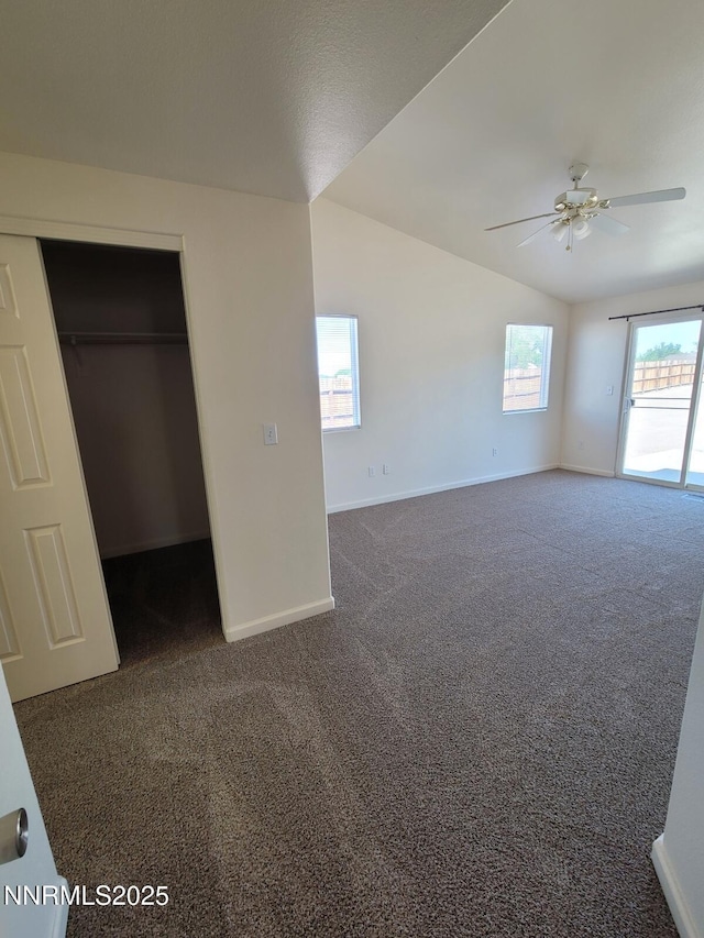 159 Shadow Mountain Dr, Fernley, NV 89408 - unfurnished bedroom featuring dark colored carpet, baseboards, lofted ceiling, and a closet