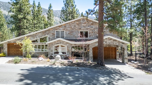 143 Granite Springs Dr, Stateline, NV 89449 - view of front facade featuring stone siding, concrete driveway, a mountain view, and a garage