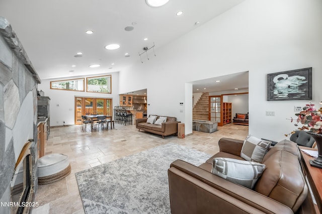 143 Granite Springs Dr, Stateline, NV 89449 - living area featuring stone tile flooring, a high ceiling, recessed lighting, and stairs