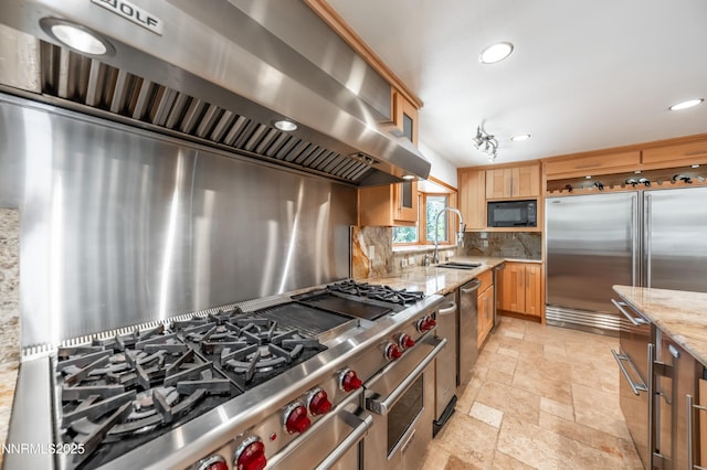 143 Granite Springs Dr, Stateline, NV 89449 - kitchen featuring built in appliances, a sink, wall chimney range hood, stone tile flooring, and backsplash