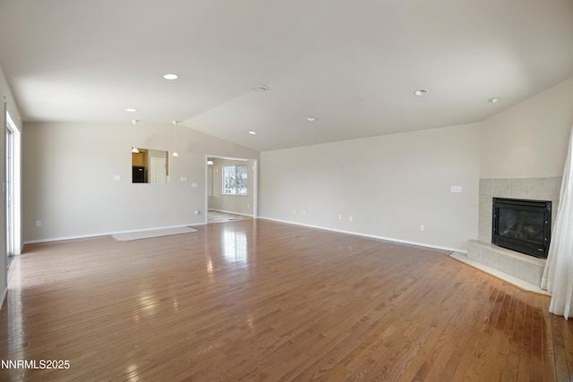 546 Yellow Jacket Rd, Dayton, NV 89403 - unfurnished living room featuring lofted ceiling, wood finished floors, a fireplace, and baseboards
