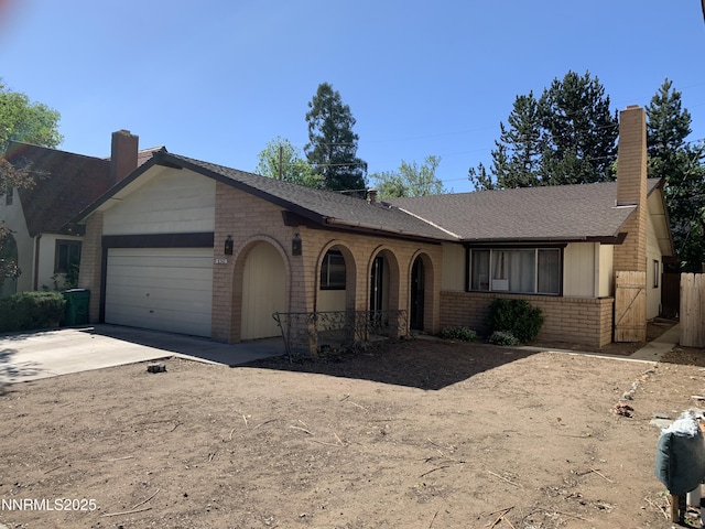 650 John Fremont Dr, Reno, NV 89509 - ranch-style home with brick siding, an attached garage, a chimney, driveway, and a shingled roof
