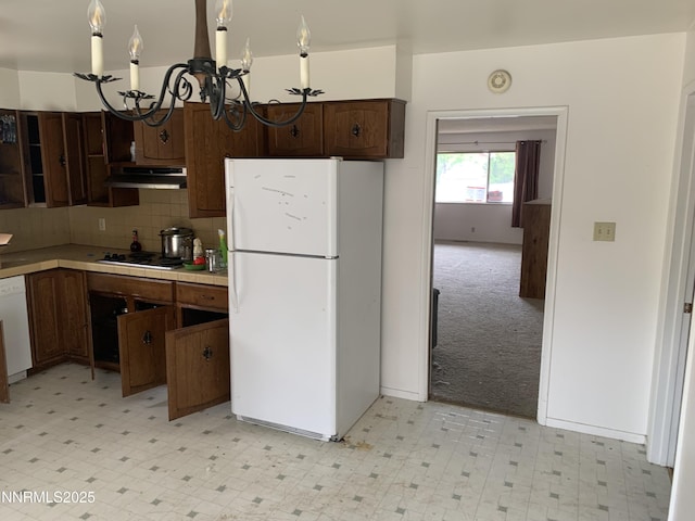 650 John Fremont Dr, Reno, NV 89509 - kitchen featuring freestanding refrigerator, a chandelier, light floors, and under cabinet range hood