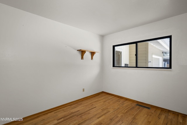 633 Crain St, Carson City, NV 89703 - empty room with wood finished floors and baseboards