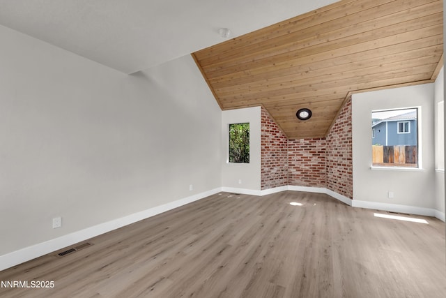 2501 Garfield Ct, Sparks, NV 89431 - unfurnished living room with lofted ceiling, wood ceiling, wood finished floors, baseboards, and brick wall