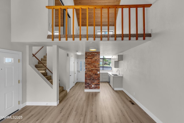 2501 Garfield Ct, Sparks, NV 89431 - foyer featuring baseboards, light wood-style flooring, stairs, and a high ceiling