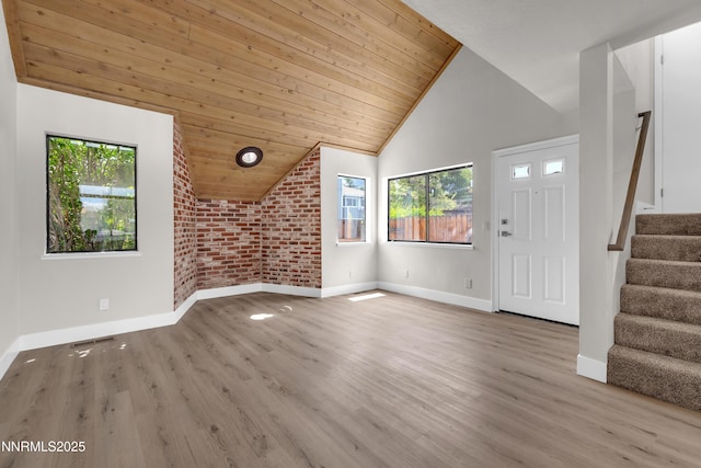 2501 Garfield Ct, Sparks, NV 89431 - unfurnished living room featuring healthy amount of natural light, wood ceiling, baseboards, stairway, and wood finished floors