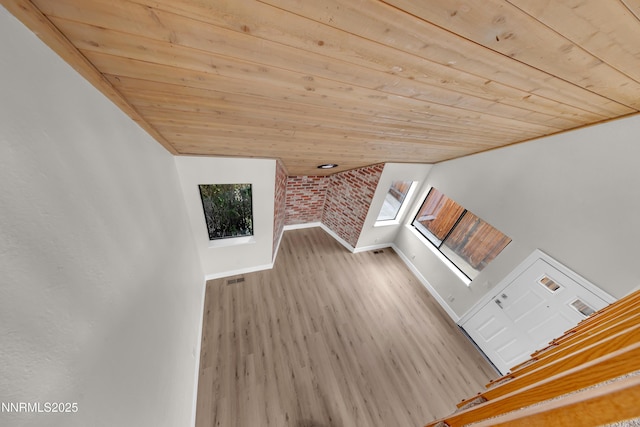 2501 Garfield Ct, Sparks, NV 89431 - staircase with wood ceiling, wood finished floors, baseboards, plenty of natural light, and brick wall