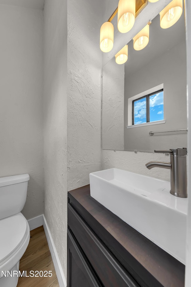 2501 Garfield Ct, Sparks, NV 89431 - bathroom featuring toilet, baseboards, vanity, and wood finished floors