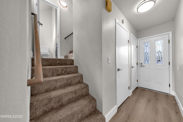 2501 Garfield Ct, Sparks, NV 89431 - foyer entrance featuring light wood finished floors, stairway, and baseboards