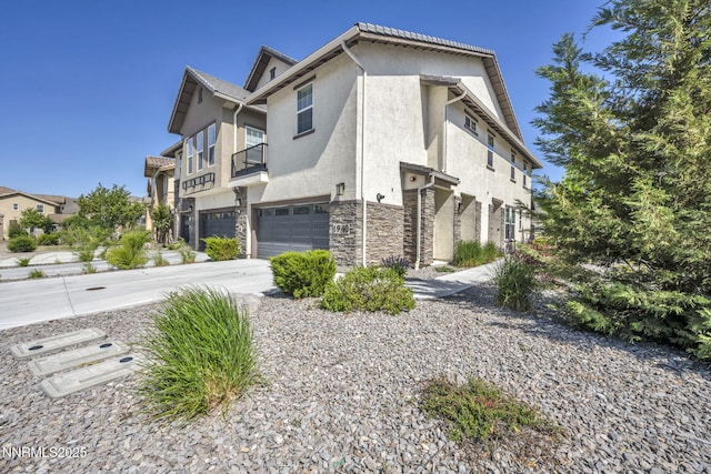 1940 Dark Horse Rd Unit C, Reno, NV 89521 - view of property exterior with a garage, stucco siding, and stone siding