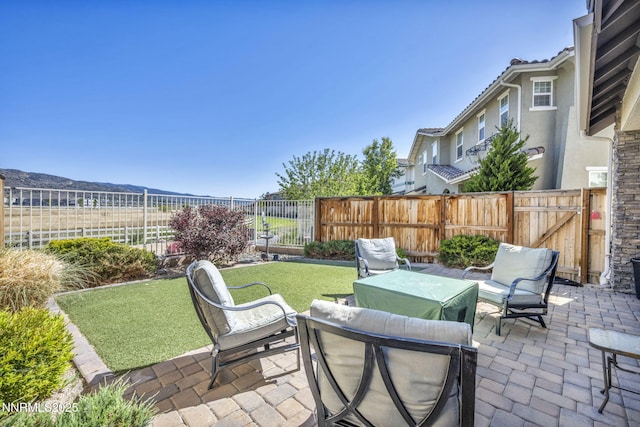 1940 Dark Horse Rd Unit C, Reno, NV 89521 - fenced backyard with a patio area, an outdoor hangout area, a mountain view, and a gate