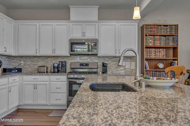 1940 Dark Horse Rd Unit C, Reno, NV 89521 - kitchen with appliances with stainless steel finishes, a sink, wood finished floors, and white cabinets