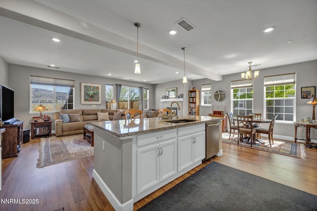 1940 Dark Horse Rd Unit C, Reno, NV 89521 - kitchen featuring a sink, stainless steel dishwasher, dark wood-style flooring, open floor plan, and white cabinetry