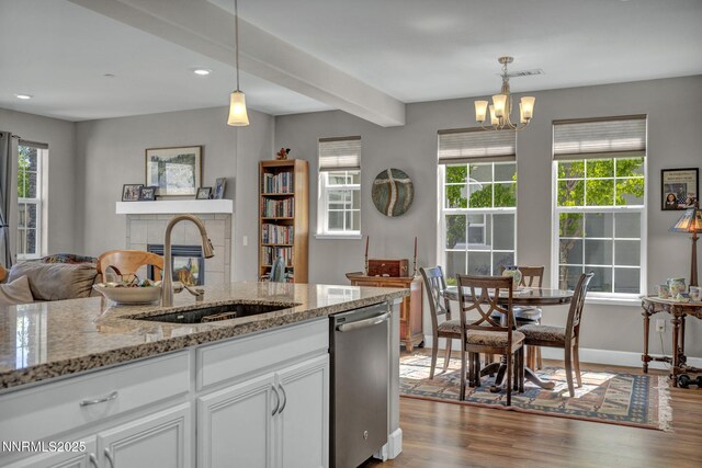 1940 Dark Horse Rd Unit C, Reno, NV 89521 - kitchen with stainless steel dishwasher, a sink, wood finished floors, white cabinetry, and recessed lighting