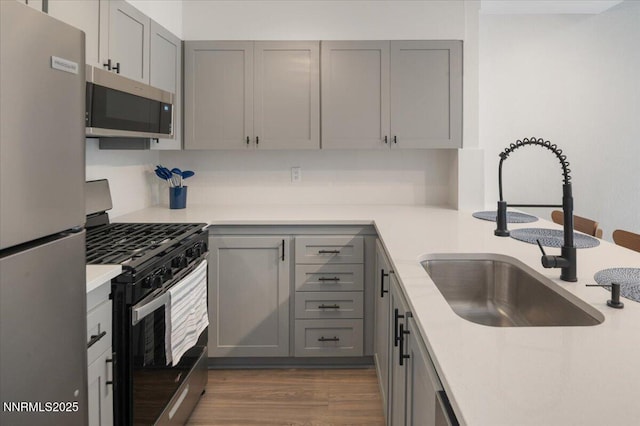 807 Alder Ave Unit 10, Incline Village, NV 89451 - kitchen with freestanding refrigerator, gas range, stainless steel microwave, and gray cabinets