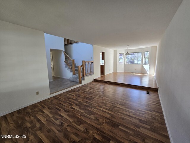 986 Quail Hollow Dr, Reno, NV 89511 - unfurnished living room with wood finished floors, stairs, and baseboards