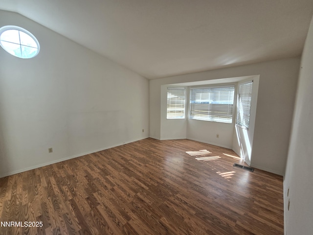 986 Quail Hollow Dr, Reno, NV 89511 - unfurnished room with vaulted ceiling, healthy amount of natural light, wood finished floors, and baseboards