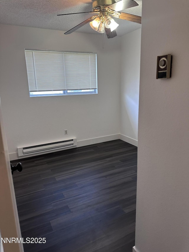 528 Smithridge Park, Reno, NV 89502 - spare room with baseboard heating, dark wood-style floors, a ceiling fan, baseboards, and a textured ceiling