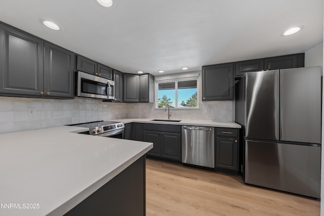 583 Marta Way, Reno, NV 89503 - kitchen featuring appliances with stainless steel finishes, a sink, light countertops, tasteful backsplash, and recessed lighting